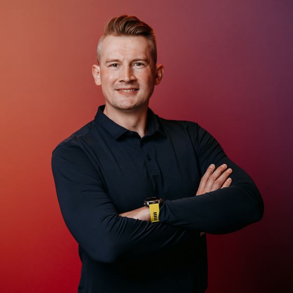 Viktor Gamov with arms crossed, smiling