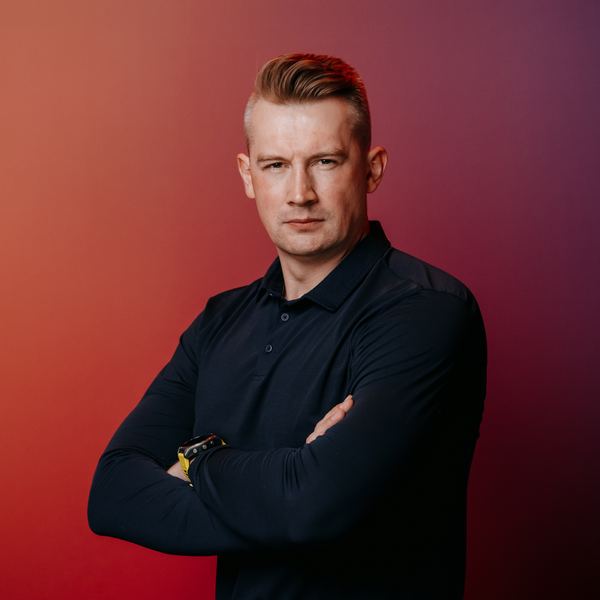 Viktor Gamov with arms crossed, serious expression