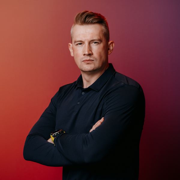 Viktor Gamov with arms crossed, looking at the camera